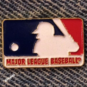 May include: A rectangular pin featuring the Major League Baseball logo. The pin has a white batter silhouette on a blue and red background. The words "MAJOR LEAGUE BASEBALL" are in red letters at the bottom, with a gold border.