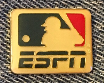 May include: A gold-colored pin with a black and red baseball logo and the word "ESPN" in black letters.
