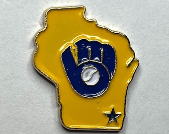 May include: A yellow and blue enamel pin in the shape of the state of Wisconsin. The pin features a blue baseball glove with a white baseball in the center. A blue star is in the lower right corner.