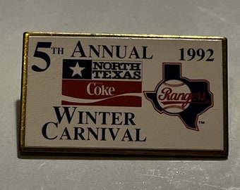 May include: A gold-colored pin with a white background. The pin features the text "5th Annual 1992", a star with the text "North Texas", a Coca-Cola logo, and a Texas-shaped outline with the text "Rangers" and a baseball inside. The text "Winter Carnival" is also featured on the pin.