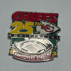 May include: A Chiefs 25th Anniversary pin featuring the team's logo, the words "CHIEFS" in red, and "25th ANNIVERSARY" in yellow. The pin also includes an image of Arrowhead Stadium.