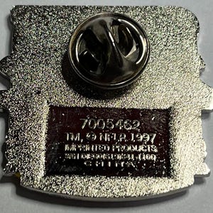 May include: A silver-colored pin with a pin back. The pin has a rectangular shape with rounded edges. The back of the pin has the text "7005462 TM, NFLP, 1997, IMPRINTED PRODUCTS, 2010 NFL PROPERTIES LLC, CHINA."