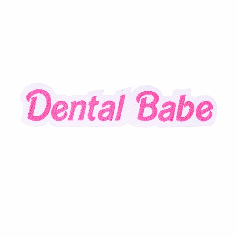 May include: Pink embroidered patch with the text "Dental Babe" on a white background.