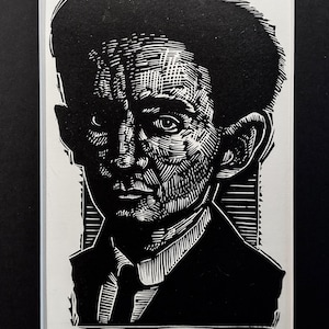 May include: Black and white woodcut print of Franz Kafka, a famous author. The print is signed "Franz Kafka" AIP Sean Eaby.