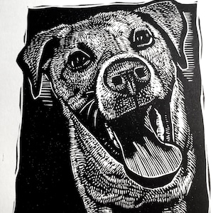 May include: Black and white woodcut print of a dog with its mouth open and tongue sticking out. The dog is looking directly at the viewer.