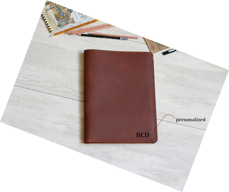 May include: A brown leather notebook cover with the initials "BCD" embossed on the front. The cover is personalized with the initials.