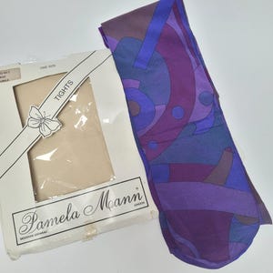 May include: A pair of patterned tights in shades of purple, blue, and burgundy, next to a package of nude-coloured tights. The package is labelled "Pamela Mann London" and "Tights."