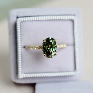 Olive green moissanite ring. Forever one moissanite engagement ring. Oval engagement ring. Yellow gold engagement ring. Gemstone ring