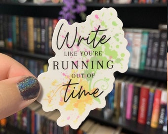 May include: White sticker with colorful paint splatters and the text "Write like you're running out of time".