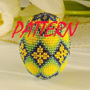 May include: A yellow, green, and blue beaded Easter egg with a geometric pattern. The egg is made of small beads and has a shiny finish.