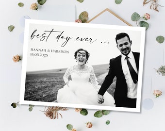 May include: Black and white wedding photo of a couple running towards the camera. The bride is wearing a white dress and the groom is wearing a black suit. The text "best day ever..." is written above the photo. The text "HANNAH & HARRISON 18.05.2025" is written below the photo.