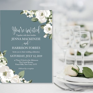 May include: A blue wedding invitation with white flowers and the text "You're invited"  "Together with their families" "Jenna Mackenzie and Harrison Forbes" "Invite you to their wedding celebration" "Saturday, July 12, 2019" "at Three O'clock in the Afternoon" "The Crystal Rooms, Forest Hills, New York, 11375" "Followed by a reception"