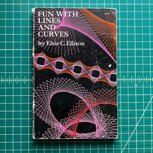 May include: A paperback book titled Fun with Lines and Curves by Elsie C. Ellison. The black cover features geometric string art patterns in vibrant pink and orange thread designs. The text is printed in white, and the price $1.75 is visible.