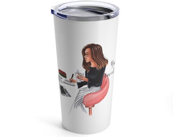 May include: White stainless steel tumbler with a colorful illustration of a woman sitting in a pink chair, working on a laptop and holding a cup of coffee. The text "You got this" is written on the tumbler.