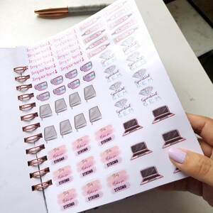 May include: A planner with sticker sheets featuring various designs. Stickers include the words "Important!", teacups, books, laptops, and the phrase "Study Makes You Strong". A rose gold pen rests on the planner.