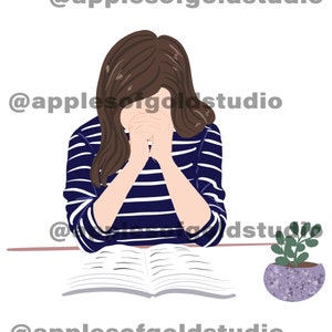May include: A woman with brown hair is sitting at a table with her hands clasped together in prayer. She is wearing a blue and white striped shirt. An open book is in front of her and a potted plant is on the table to the right.