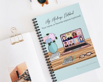 May include: A spiral-bound notebook with a light blue cover featuring the text "My Meetings Notebook." The cover illustration includes a laptop displaying a video call, a vase of flowers, and other desk items. The notebook is open to a blank page.