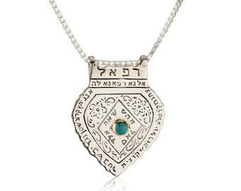 May include: Silver necklace with a pendant featuring a turquoise stone and Hebrew text. The pendant is shaped like a heart and has intricate details.