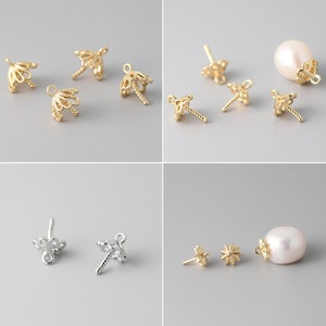 May include: A set of gold and silver earring findings with a variety of designs, including a flower, a star, and a pearl. The findings are perfect for making your own earrings.