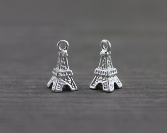 May include: Two silver Eiffel Tower charms with a loop at the top for attaching to jewelry or other crafts.