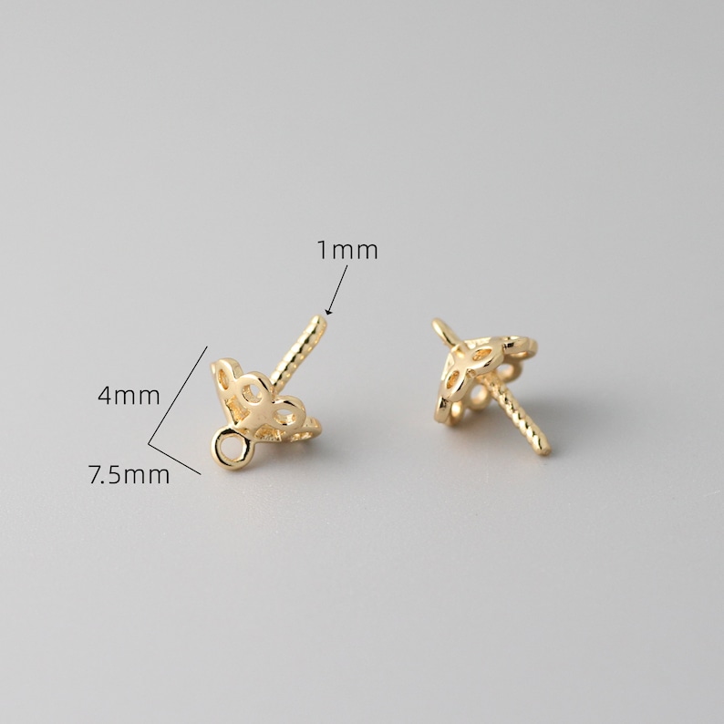 May include: Two gold-toned metal bead caps with a decorative filigree design. The caps are 7.5 mm wide, 4 mm tall, and have a 1 mm diameter hole.