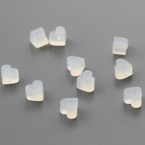 May include: A group of ten translucent white heart-shaped silicone earbud tips.