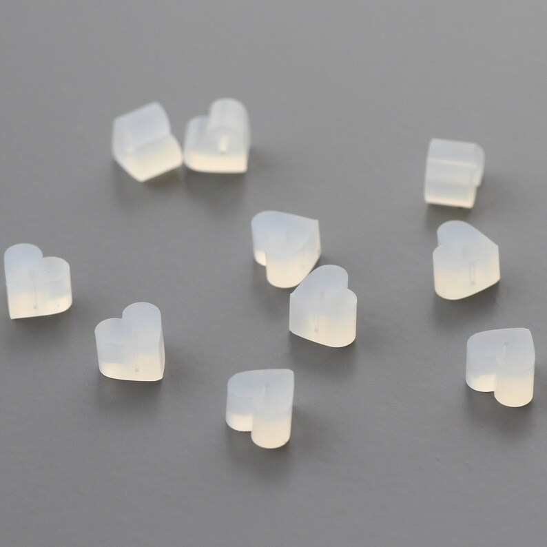 May include: A group of ten translucent white heart-shaped silicone earbud tips.