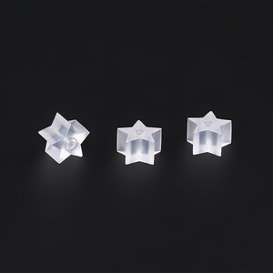 May include: Three clear plastic star-shaped earring backs.