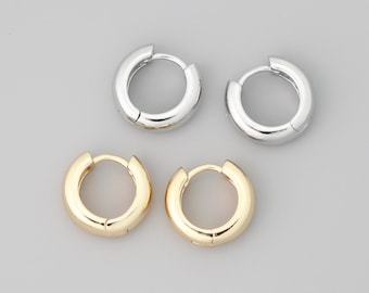 May include: Four hoop earrings, two silver and two gold. The earrings are all the same size and shape.