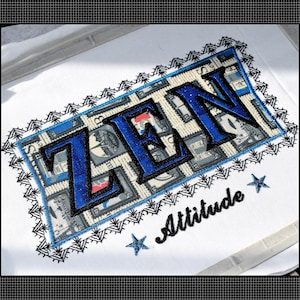 May include: Embroidered patch with the word "ZEN" in blue, outlined in black, on a background of postage stamp imagery. The patch is bordered by a blue frame and a black, spiky trim. The word "Attitude" and two blue stars are below.