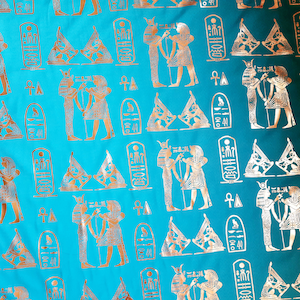 Light teal fabric with ancient Egypt printings. For a unique Egyptian syle, clothing or uphosltery. Sold by 50 cm - 20 in