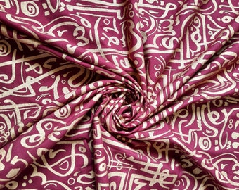 Burgundy Fabric with Metallic Arabic Calligraphy Prints. Perfect for Draped Evening Attire or Stylish Accessories. Price for 50 cm - 20"