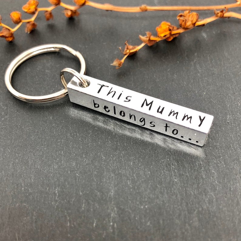 May include: Silver keychain with a rectangular tag that reads "This Mummy belongs to..."
