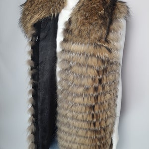 May include: A brown and black fur vest with a large fur collar. The vest is sleeveless and has a black lining.