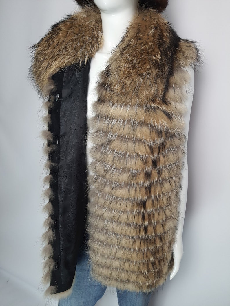 May include: A brown and black fur vest with a large fur collar. The vest is sleeveless and has a black lining.