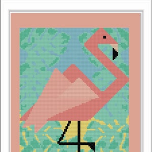 May include: A pink flamingo with a black head and legs stands on one leg against a background of green and blue leaves.