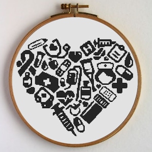 May include: Black and white cross-stitch pattern of a heart filled with medical symbols, including a stethoscope, pills, bandages, and a syringe. The pattern is framed in a wooden hoop.