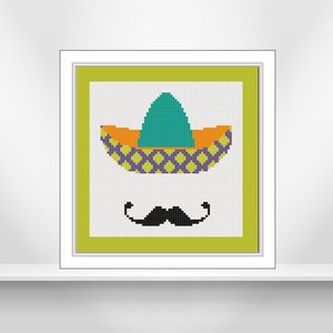 Puede incluir: Un diseño de punto de cruz enmarcado que presenta un sombrero colorido y un bigote negro sobre un fondo verde.