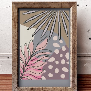 Puede incluir: Una impresión de arte digital enmarcada que presenta un diseño abstracto rosa y marrón con un patrón de hojas. El fondo es gris claro con lunares blancos.