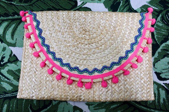 straw clutch with pom poms