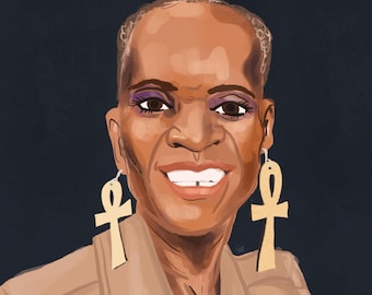 May include: A portrait of a woman with short, dark hair. She is wearing a tan jacket and large gold earrings shaped like an ankh. She is smiling with her teeth showing.
