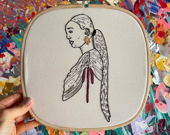 Side portrait of a woman with a gold earring and pink bow - 10 inch square hoop