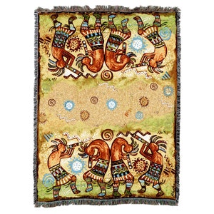 May include: A woven tapestry throw blanket featuring a colorful design of Native American dancers in a circle. The dancers are depicted in a stylized, geometric style with brown, red, blue, and green colors. The background is a light beige with a subtle pattern of swirls and dots.