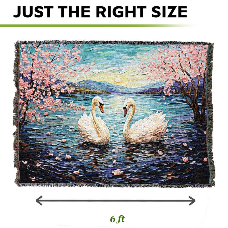 May include: A tapestry featuring a scenic landscape with two white swans swimming in a lake. The lake is surrounded by trees with pink blossoms and a blue sky with clouds. The tapestry is 6 feet wide and has a fringed border.