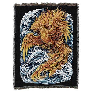 May include: A rectangular woven throw blanket featuring a black background with a central golden phoenix rising from stylized blue and white ocean waves. The phoenix has detailed orange and yellow feathers, and the blanket has a fringed edge.