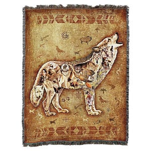 May include: A woven tapestry throw blanket featuring a brown wolf howling with a Native American design. The wolf is made up of various animal and nature images, including a bird, a deer, and a feather. The background is a tan color with brown and red accents.