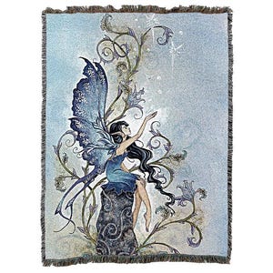 May include: A tapestry featuring a blue fairy with wings outstretched, sitting on a rock surrounded by swirling vines and flowers. The background is a light blue with a shimmery effect.