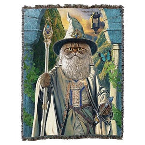 May include: Woven tapestry featuring a cat dressed as a wizard, complete with a hat, staff, and long white beard. The cat is set against a backdrop of a fantasy landscape with a lantern and a butterfly. The tapestry has a fringed edge.