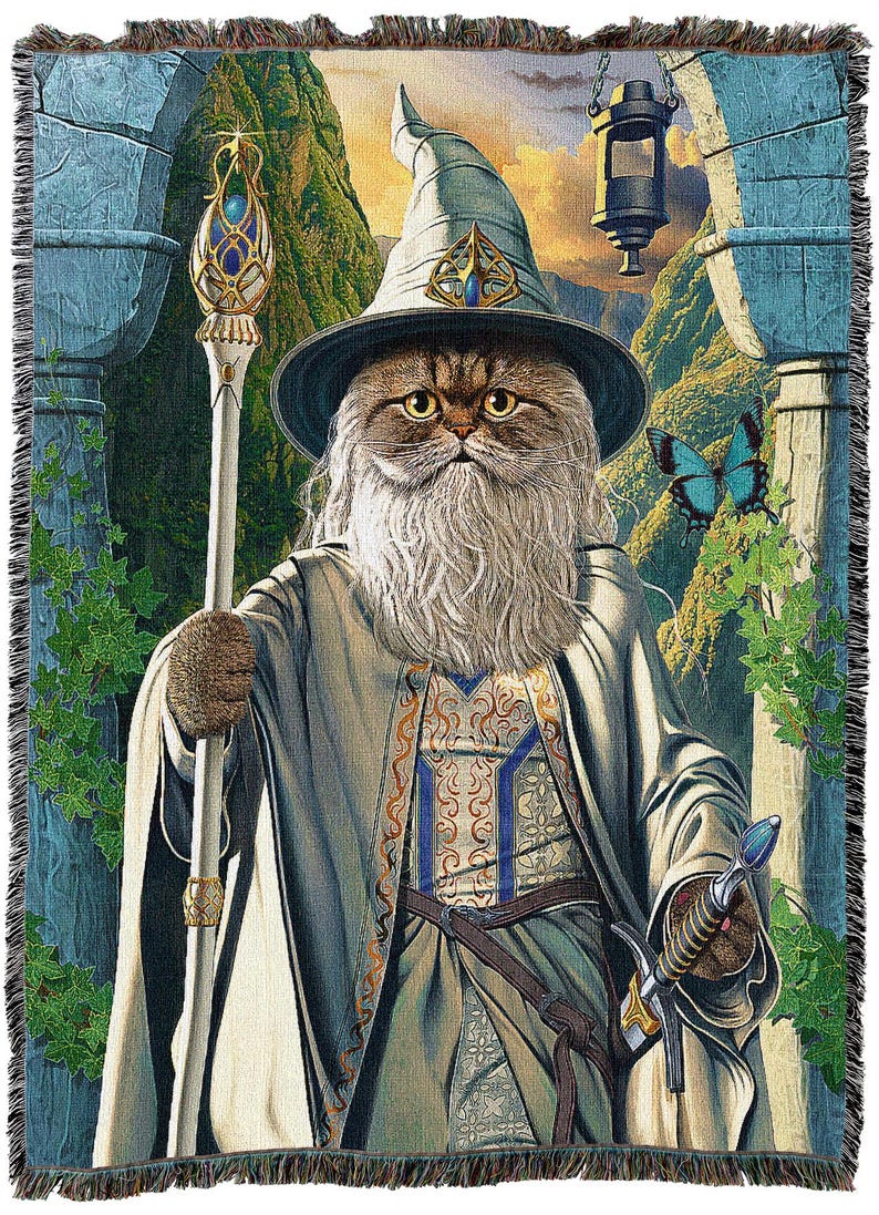 May include: Woven tapestry throw blanket featuring a cat dressed as a wizard, complete with a hat, staff, and sword. The cat has a long white beard and is set against a fantasy landscape with a blue butterfly.