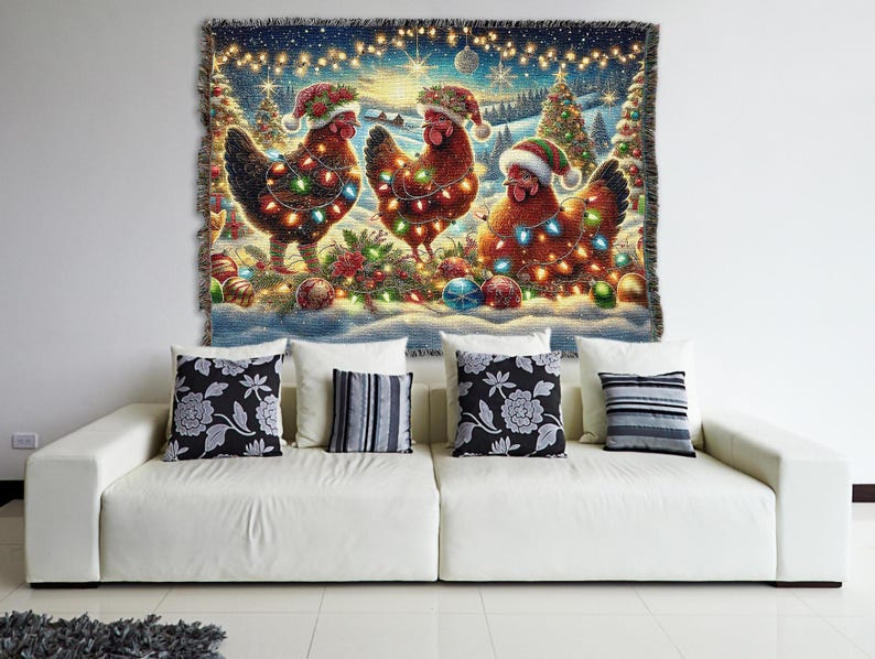 May include: A woven tapestry blanket featuring a festive winter scene with three brown chickens wearing Santa hats and wrapped in colorful string lights. The background displays snow-covered pine trees, glowing fairy lights, and Christmas ornaments.